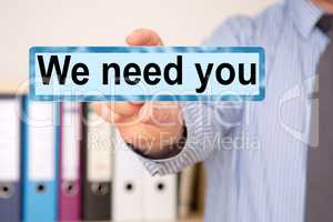 Businessman holding sign with inscription, We need you