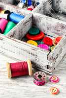 Buttons and spool of thread