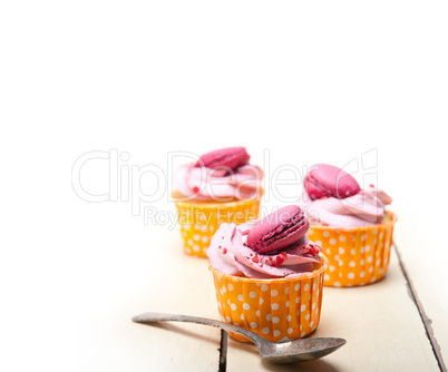 pink berry cream cupcake with macaroon on top