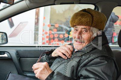 Vital elderly man in a car
