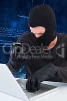Thief taking picture document on laptop