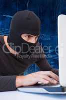 Masked man using laptop