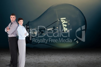 Business people standing in front of light bulb