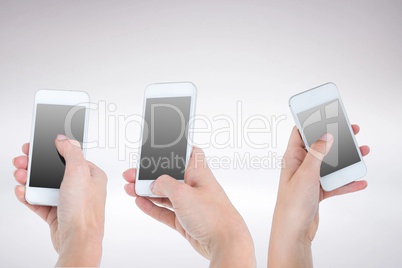 Three hands holding smartphones Three hands holding smartphones