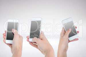 Three hands holding smartphones