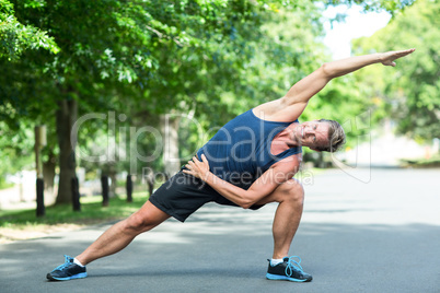 Sportsman stretching in park