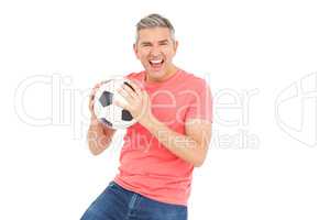 Happy man holding a soccer ball
