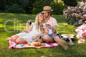 Happy couple having a picnic and embracing