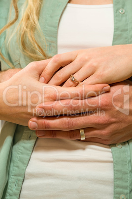 Close up of couple hands wearing wedding rings