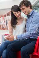 Happy couple looking at mobile phone