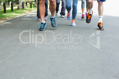 Cropped view of marathon athletes feet running