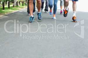 Cropped view of marathon athletes feet running