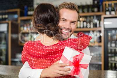 A couple hugging in a bar