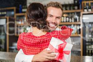 A couple hugging in a bar