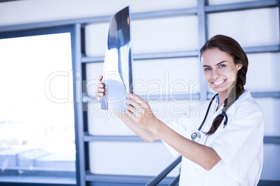 Portrait of female doctor holding a x report