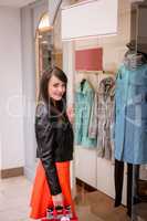 Portrait of woman holding shopping bags in mall