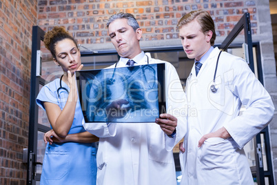 Group of doctors examining a x report