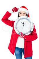 Beautiful brunette with santa hat holding a clock