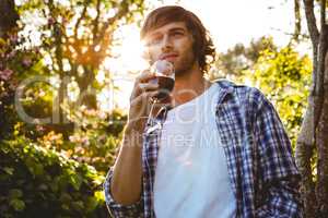 Serious man drinking red wine