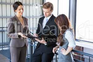 Three colleagues discussing in office