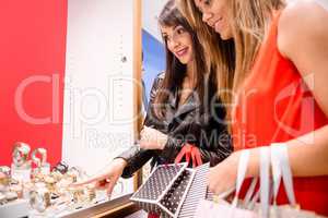 Two beautiful women looking at a display in shop