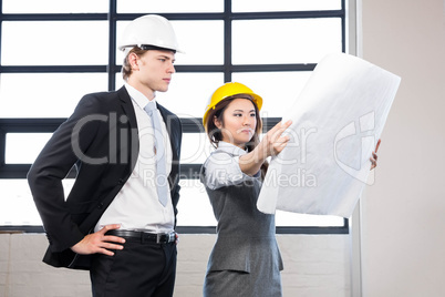 Architects looking at blueprint