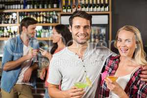 Couple toasts with cocktails