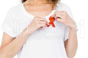 Woman wearing red aids awareness ribbon