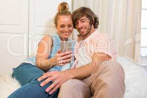 Cute couple looking at smartphone screen