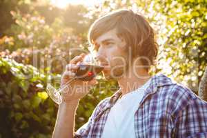 Serious man drinking red wine