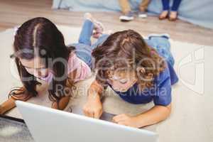 Close-up of siblings using laptop