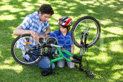 Father and son fixing the bike