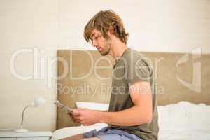 Handsome man reading a newspaper