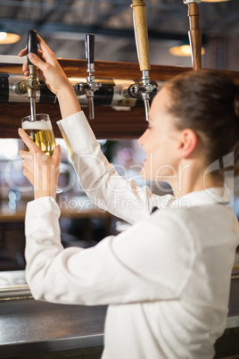 Barmaid pouring beer