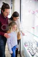 Happy family window shopping in mall