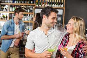 Couple toasts with cocktails