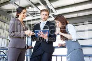 Three colleagues discussing in office