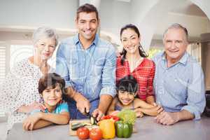 Portrait of happy family by kitchen table