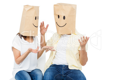 Couple covering their faces with paper bag