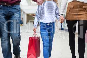 Mid section of family walking with shopping bags