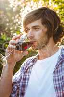 Serious man drinking red wine