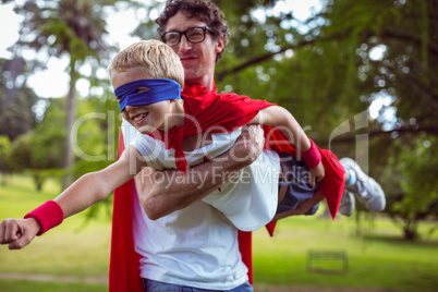 Father and son dressed as superman