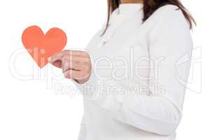 Cheerful brunette holding paper heart