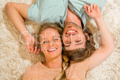 Cute couple resting on the carpet