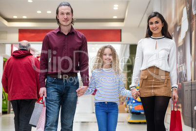 Portrait of happy family with shopping bags