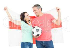 Excited football fan couple cheering at camera