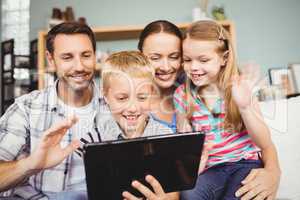 Close-up of cheerful family using technologies