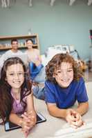 Close-up portrait of cheerful siblings with digital tablet