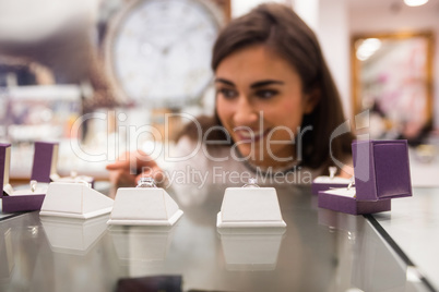 Happy woman selecting a finger ring