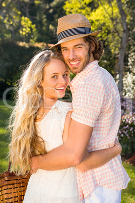 Rear view of a couple holding a picnic basket